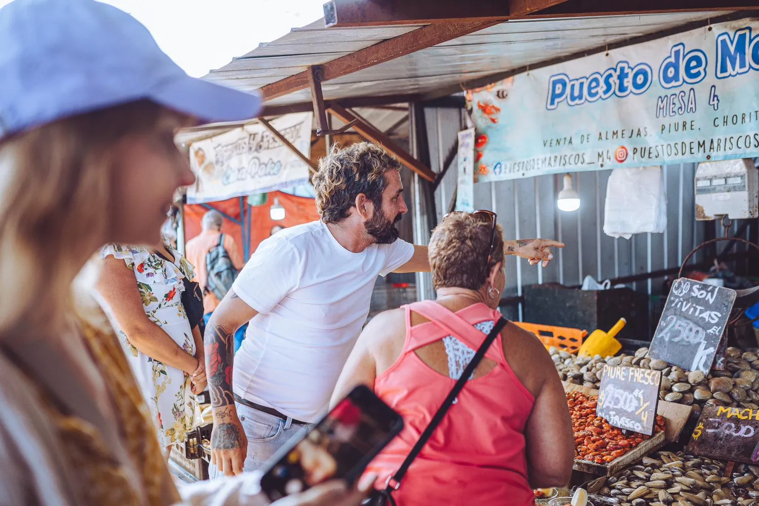 A guide explaining the fishing cove to travelers at Caleta Portales
