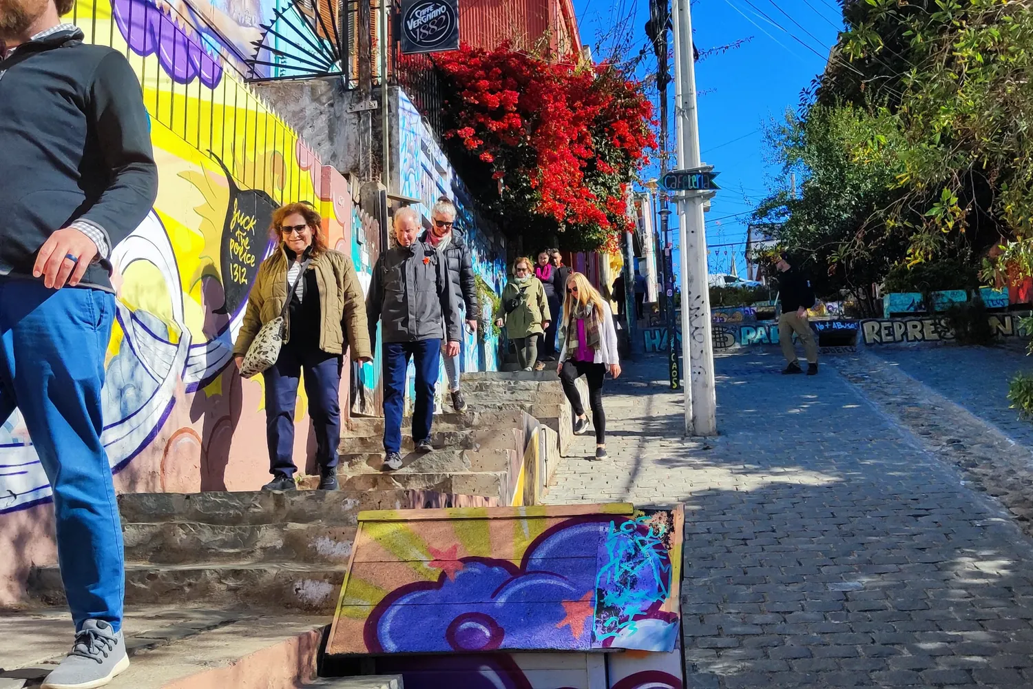 Travelers walking a colorful street in Cerro Alegre, Valparaiso